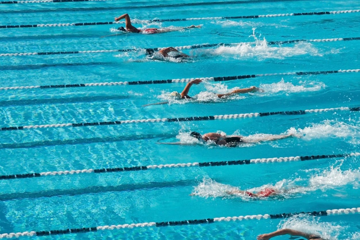 A group of swimmers swimming in the pool.